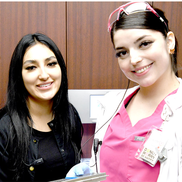 Two staff smiling