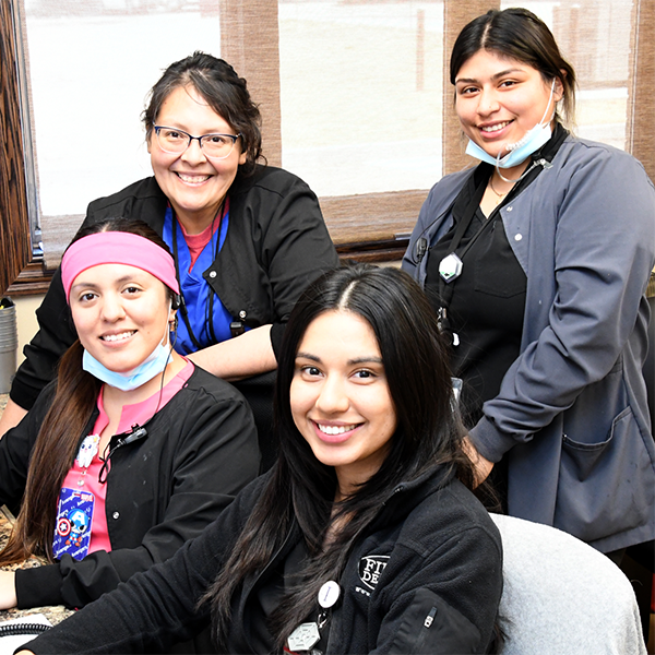 Staff posing at desk 