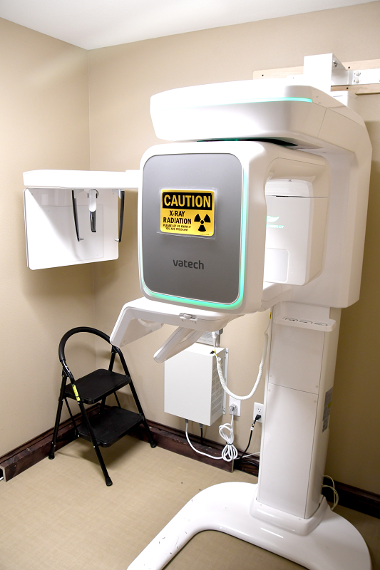 Digital panoramic X-ray machine with positioning aids and radiation safety signage