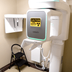 Digital panoramic X-ray machine with positioning aids and radiation safety signage