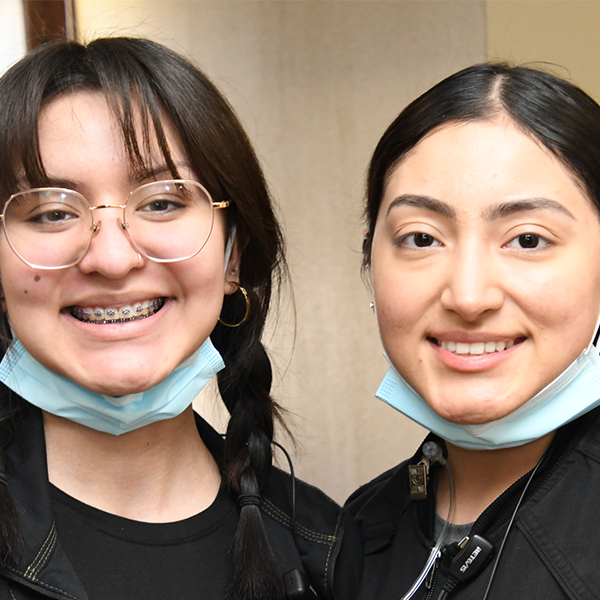 Two staff posing after treatment