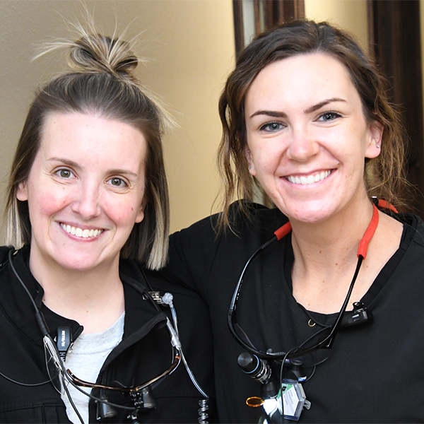 Two staff posing after treatment
