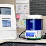 Dental laboratory station with computer, scanner, and various digital dentistry equipment