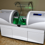 CAD/CAM dental milling machine with green illumination for same-day crown fabrication